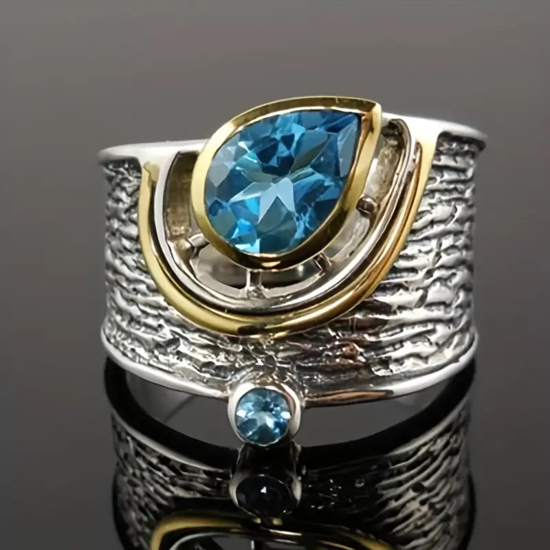 Ring aus Silber & Gold mit blauen Kristallen